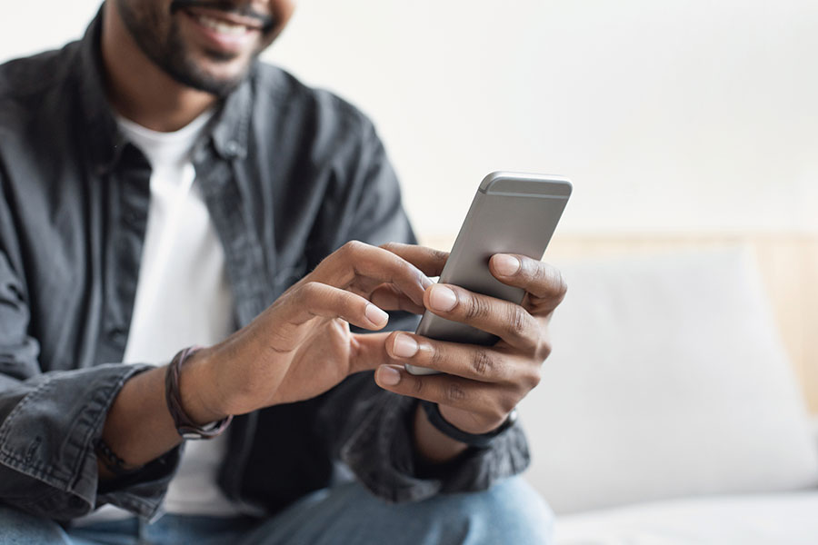 Man on a smartphone calling and ENT practice for an appointment