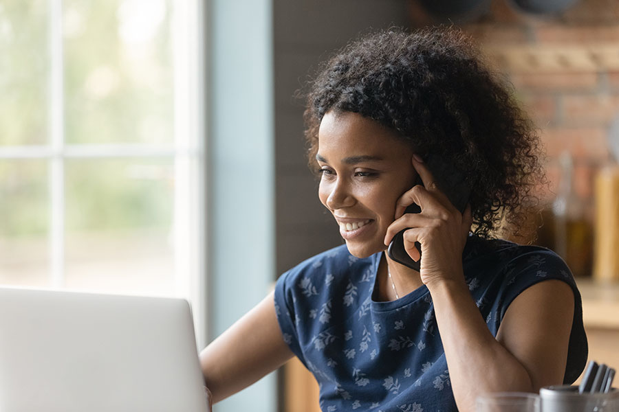 Woman calling an audiology practice while viewing their website.