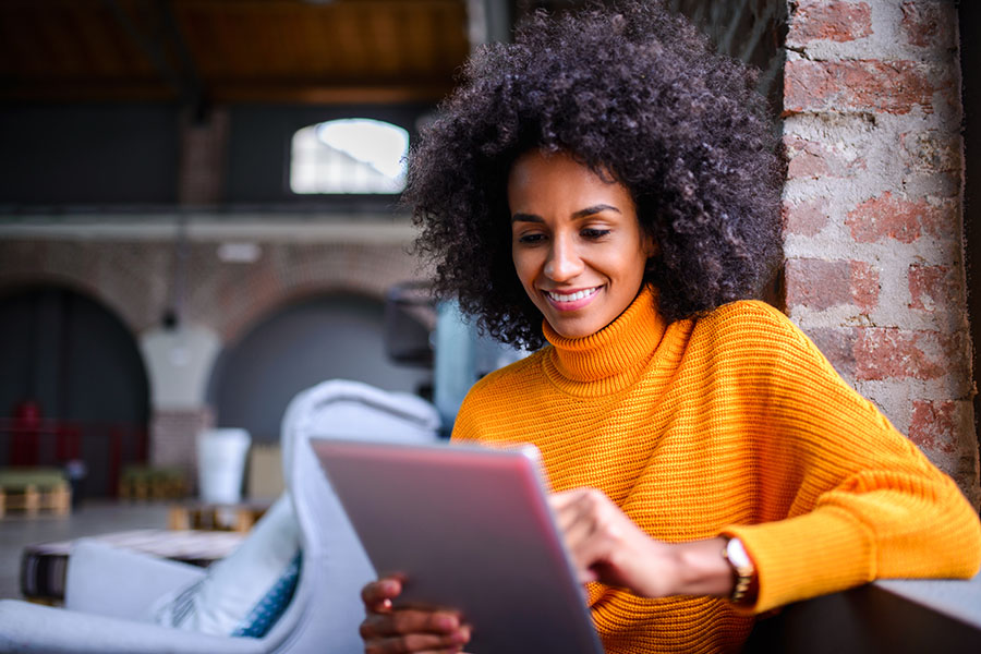 Woman on a tablet reading articles posted on social media
