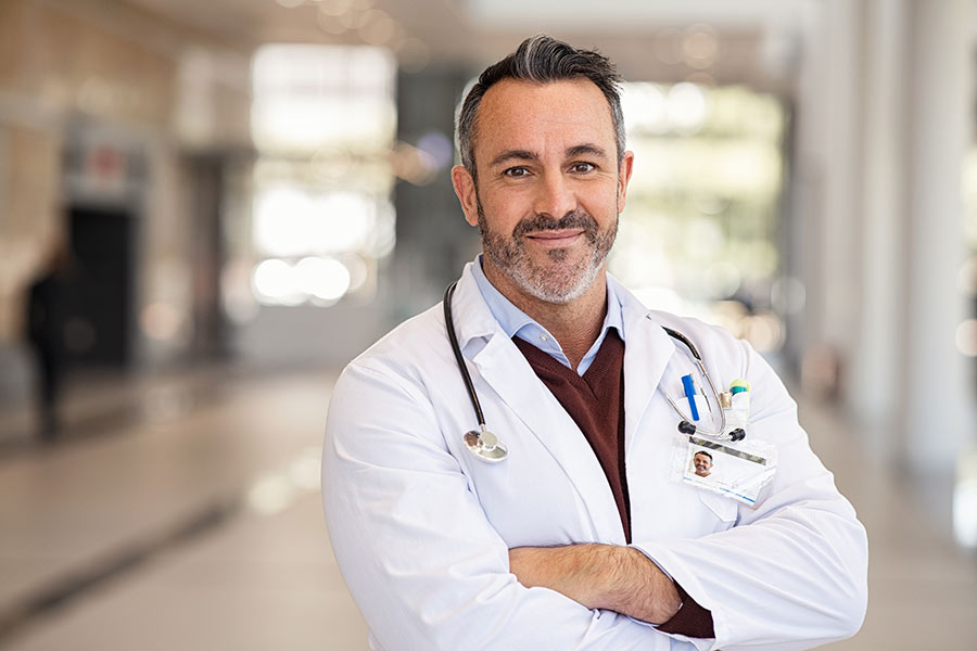 A Doctor looking satisfied with his patient reviews.